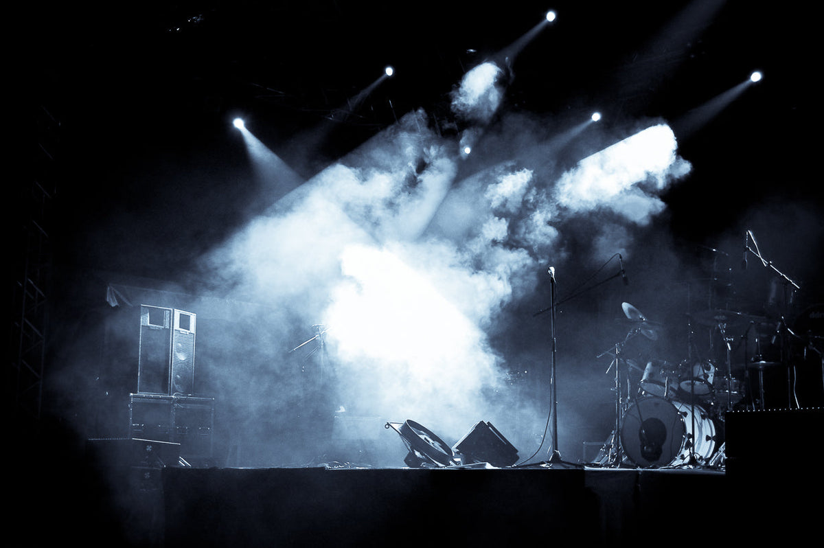 image of a stage with smoke and lights