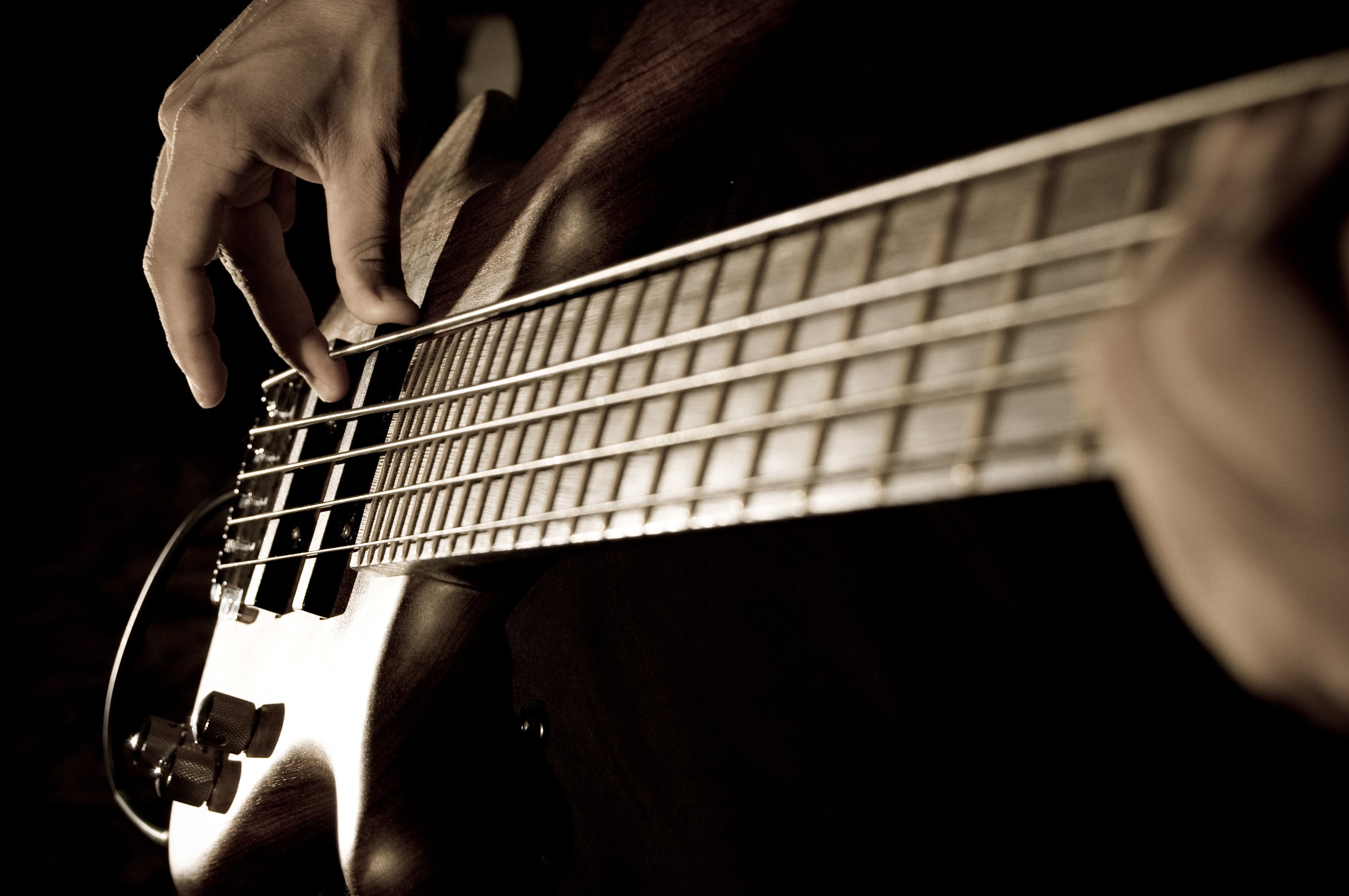 Bass guitar with players hands.