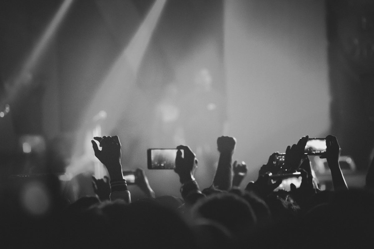 gig audience holding up phone cameras